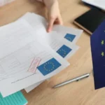 متقدم يراجع مستندات طلب تأشيرة شنغن لتجنب أسباب رفض تأشيرة الشنغن وزيادة فرص القبول.